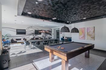 Billiards table in an updated resident clubhouse at abstract at design district in dallas tx, 75207